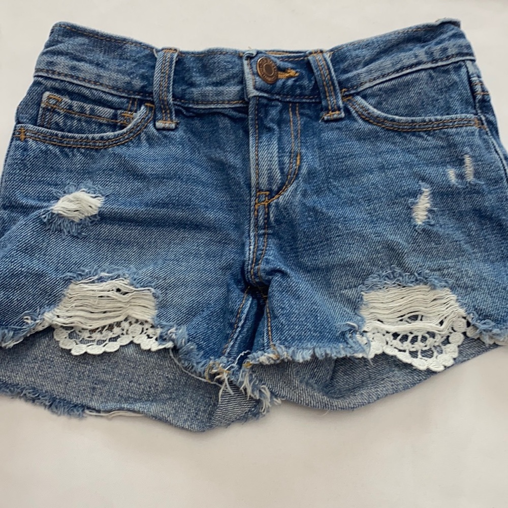 Little girls ripped jeans with lace bottom